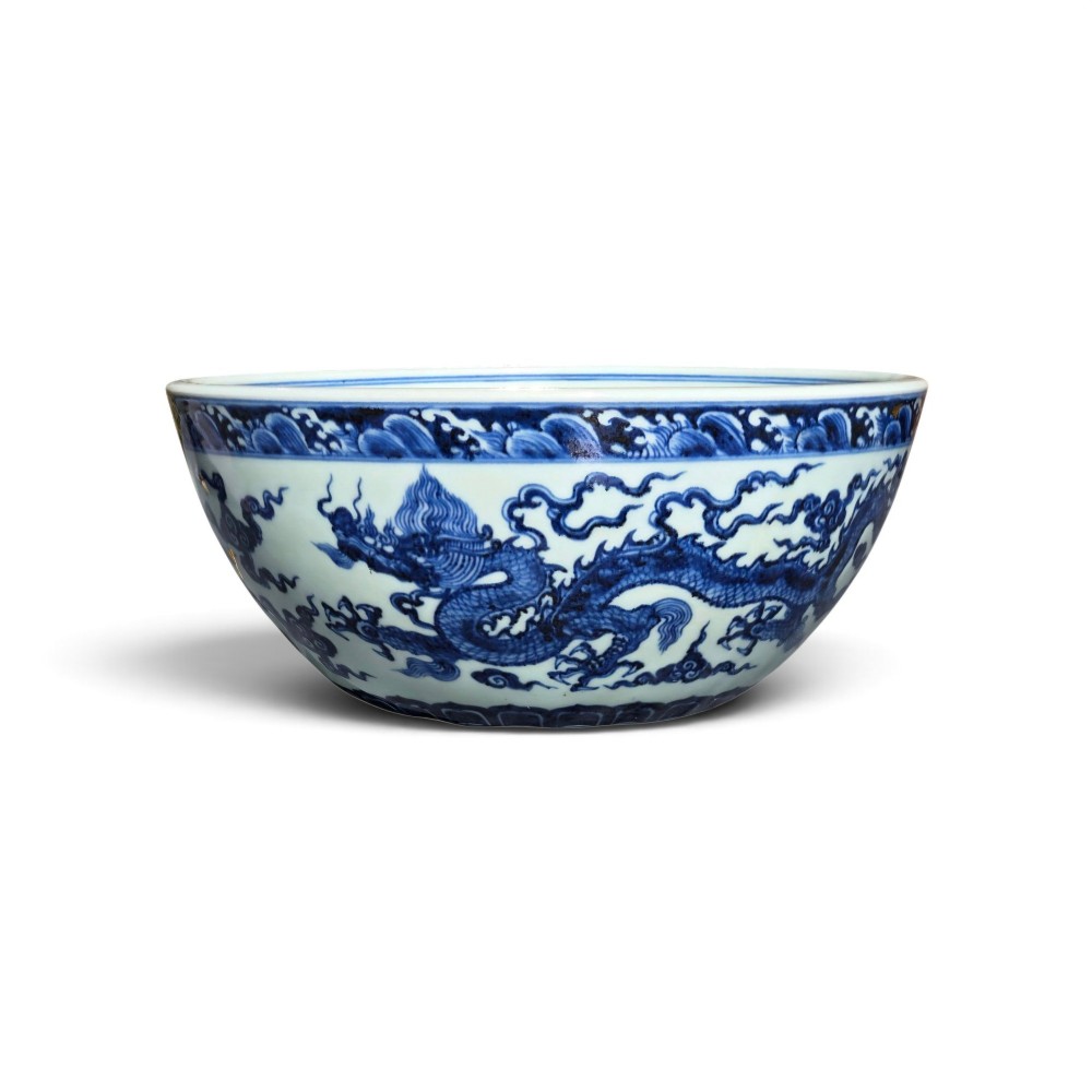 A large circular porcelain bowl featuring hand-painted cobalt blue dragons and wave motifs against a white ground. View II