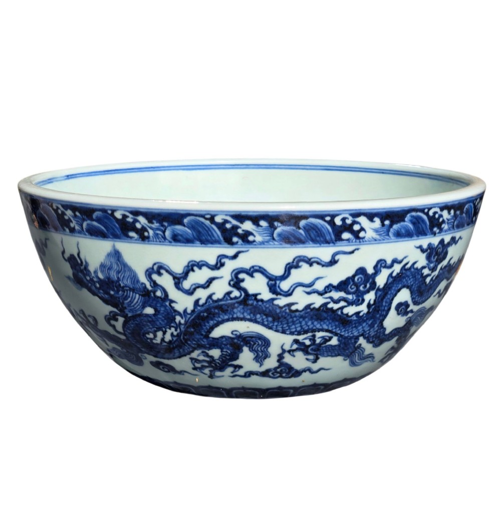 A large circular porcelain bowl featuring hand-painted cobalt blue dragons and wave motifs against a white ground. View III