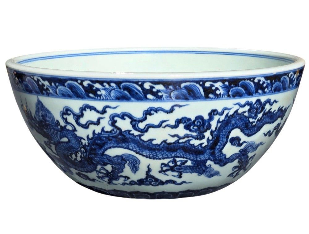 A large circular porcelain bowl featuring hand-painted cobalt blue dragons and wave motifs against a white ground. View V