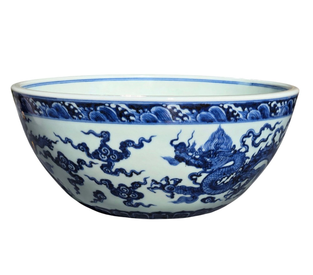 A large circular porcelain bowl featuring hand-painted cobalt blue dragons and wave motifs against a white ground. View VI