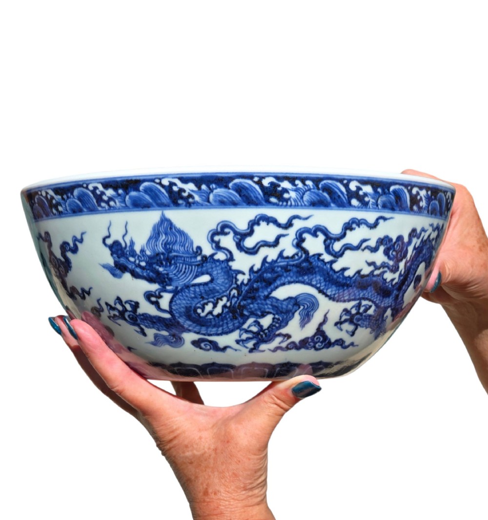 A large circular porcelain bowl featuring hand-painted cobalt blue dragons and wave motifs against a white ground. View X