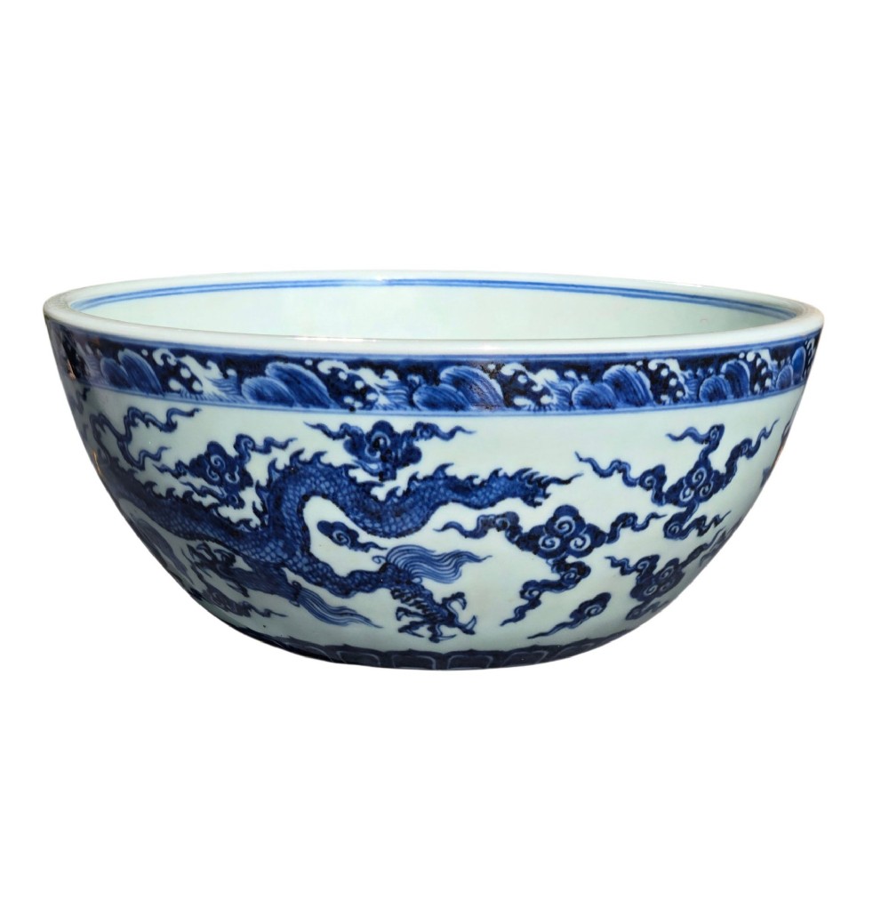 A large circular porcelain bowl featuring hand-painted cobalt blue dragons and wave motifs against a white ground. View XII