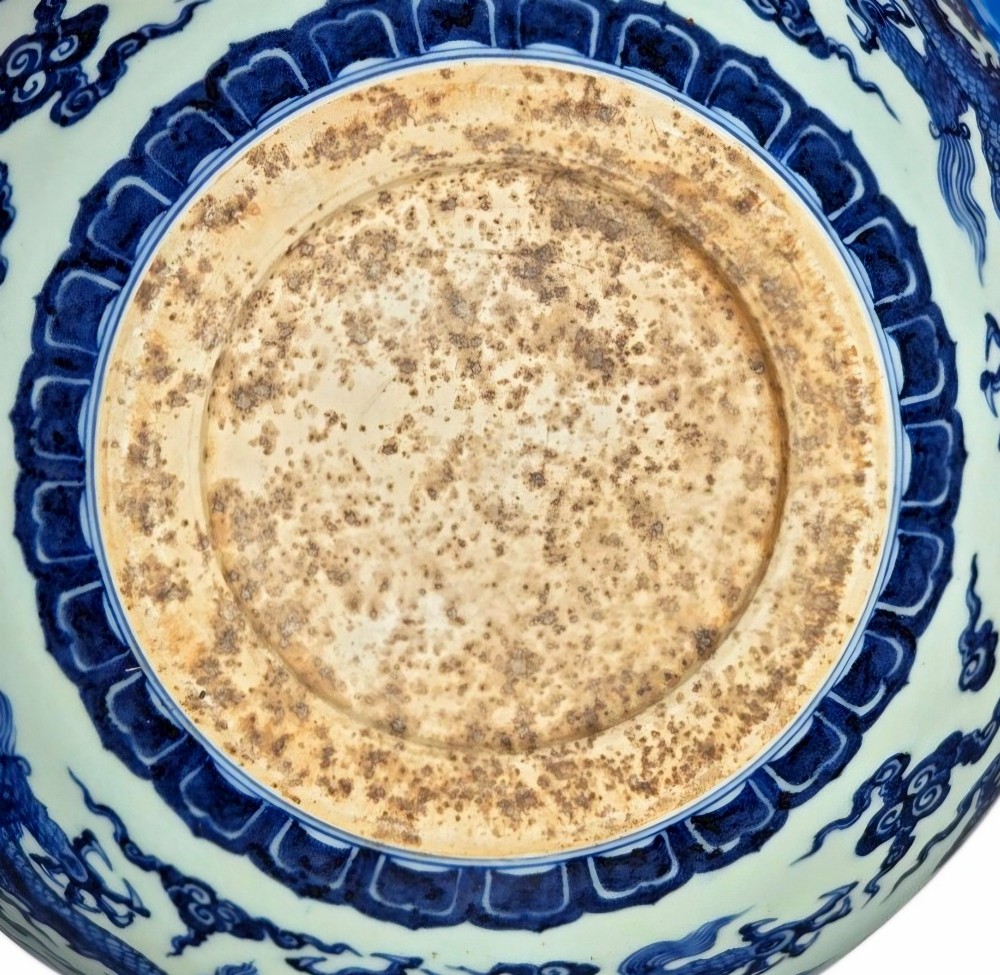 A large circular porcelain bowl featuring hand-painted cobalt blue dragons and wave motifs against a white ground. View XIII