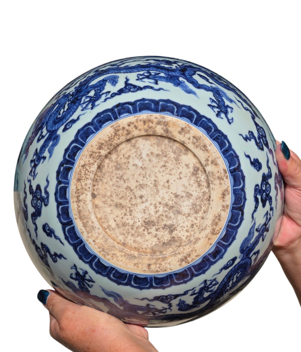 A large circular porcelain bowl featuring hand-painted cobalt blue dragons and wave motifs against a white ground. View XIV