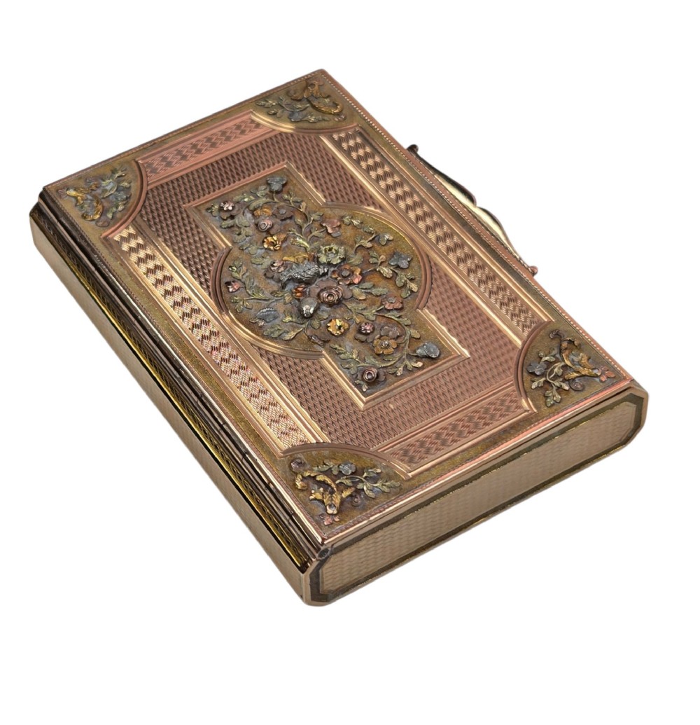 A rectangular nineteenth-century vari-colour 18ct gold snuff box featuring engine-turned guilloche patterns and a central raised floral relief panel. View IV