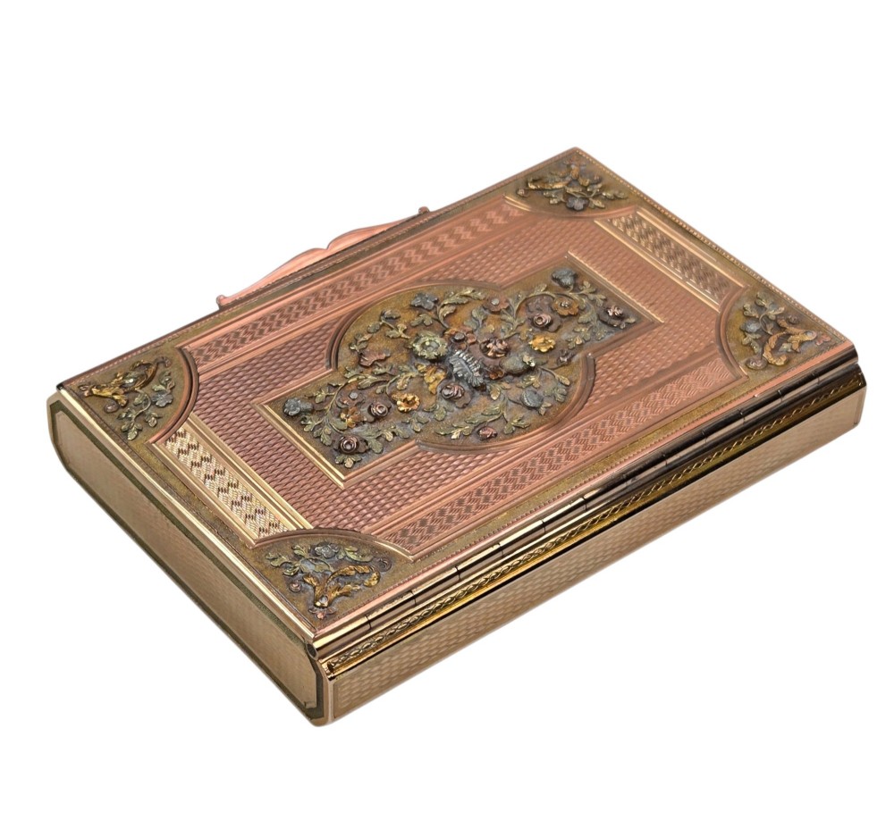 A rectangular nineteenth-century vari-colour 18ct gold snuff box featuring engine-turned guilloche patterns and a central raised floral relief panel. View V