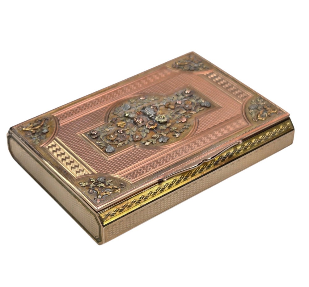 A rectangular nineteenth-century vari-colour 18ct gold snuff box featuring engine-turned guilloche patterns and a central raised floral relief panel. View VI