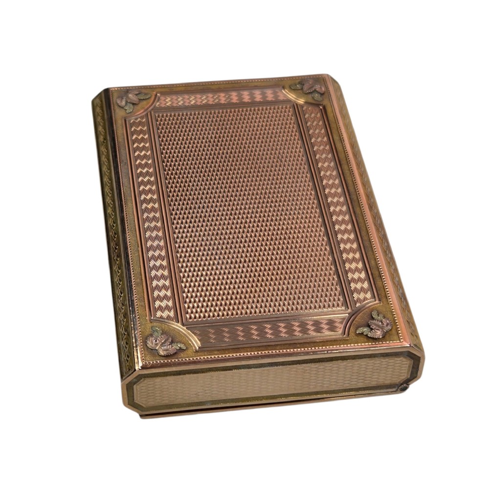 A rectangular nineteenth-century vari-colour 18ct gold snuff box featuring engine-turned guilloche patterns and a central raised floral relief panel. View VII