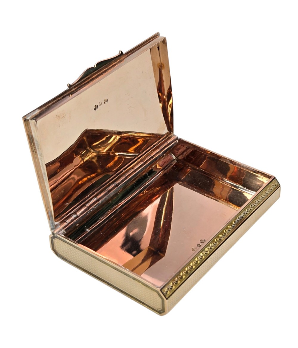 A rectangular nineteenth-century vari-colour 18ct gold snuff box featuring engine-turned guilloche patterns and a central raised floral relief panel. View IX