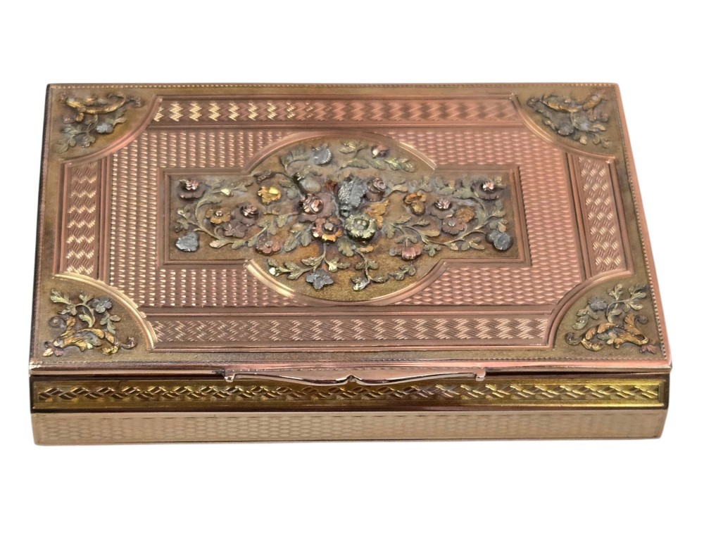 A rectangular nineteenth-century vari-colour 18ct gold snuff box featuring engine-turned guilloche patterns and a central raised floral relief panel. View XII