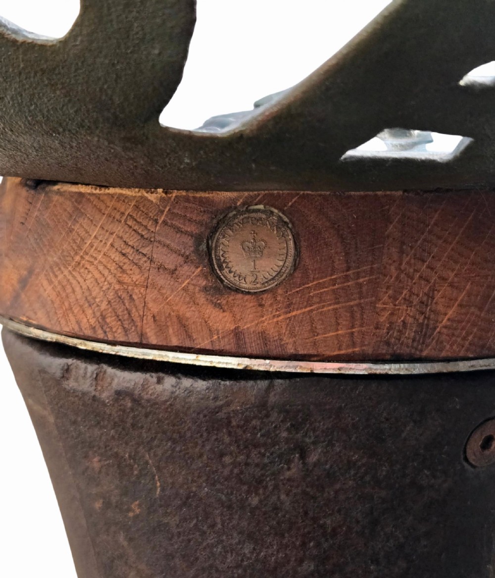 A pair of heavy industrial bar stools constructed with embossed Blackstone and Company cast-iron tractor seats, central metal columns with integrated footrests, and heavy gear cog bases. View XI