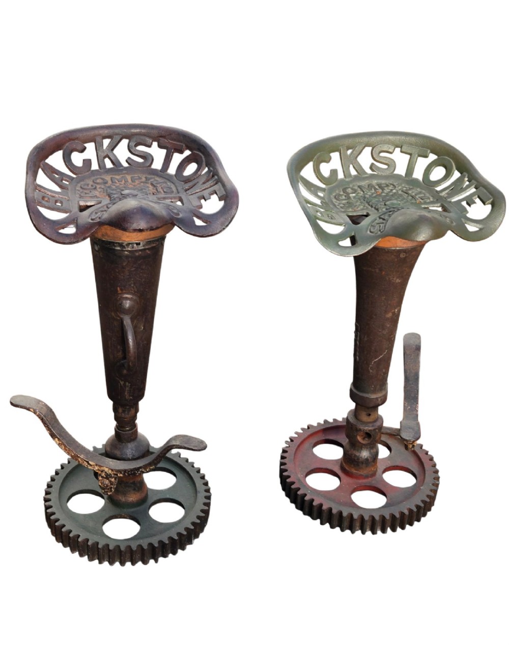 A pair of heavy industrial bar stools constructed with embossed Blackstone and Company cast-iron tractor seats, central metal columns with integrated footrests, and heavy gear cog bases. View XIII