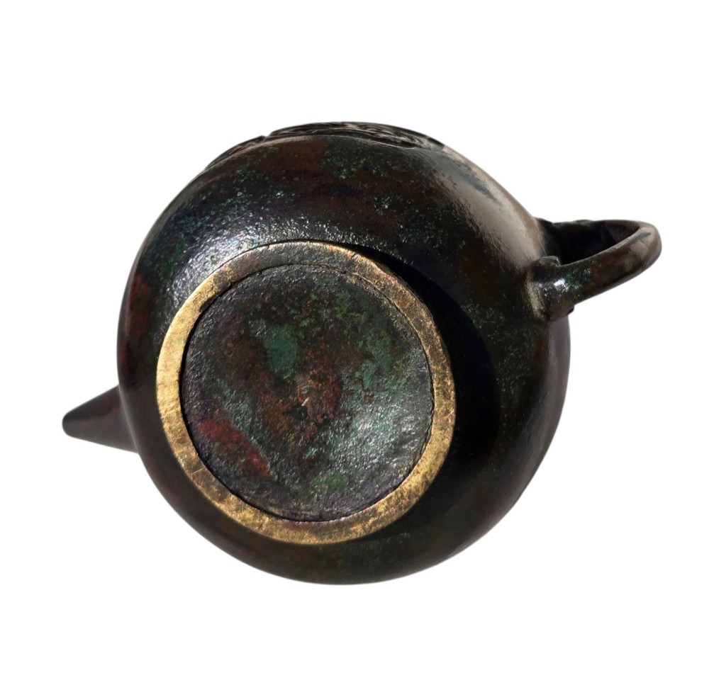 A dark patinated cast bronze vessel in ewer form featuring a dragon-head handle, a tapered spout, and carved relief panels. View XIV
