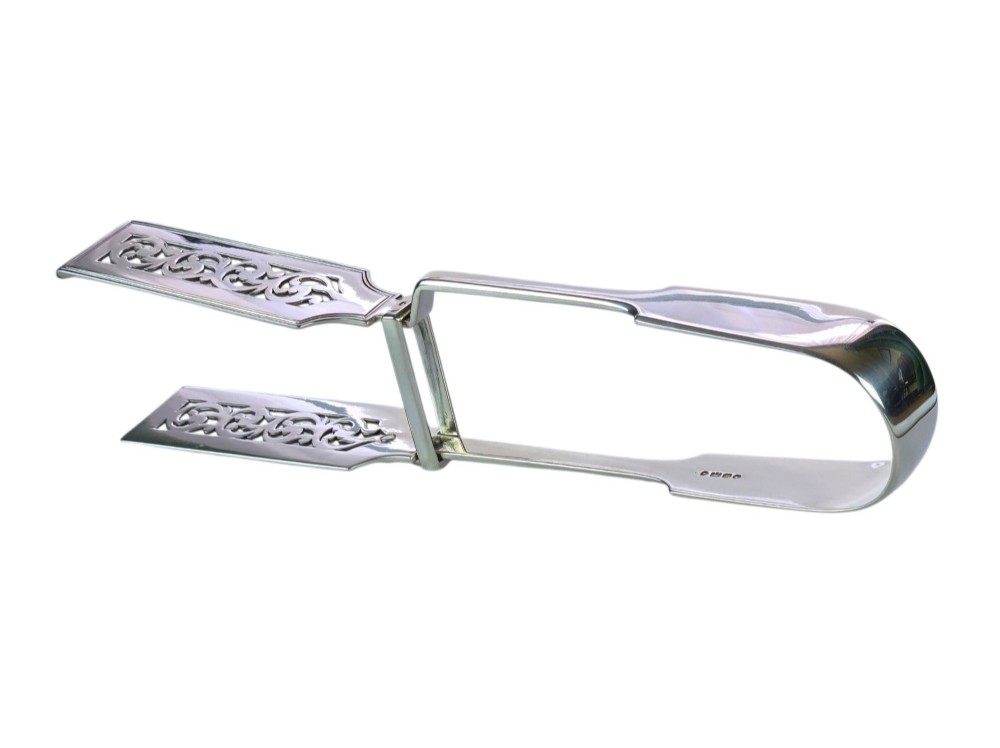 Victorian sterling silver asparagus tongs featuring wide, pierced scrollwork blades and clear assay hallmarks along the upper arm. View III