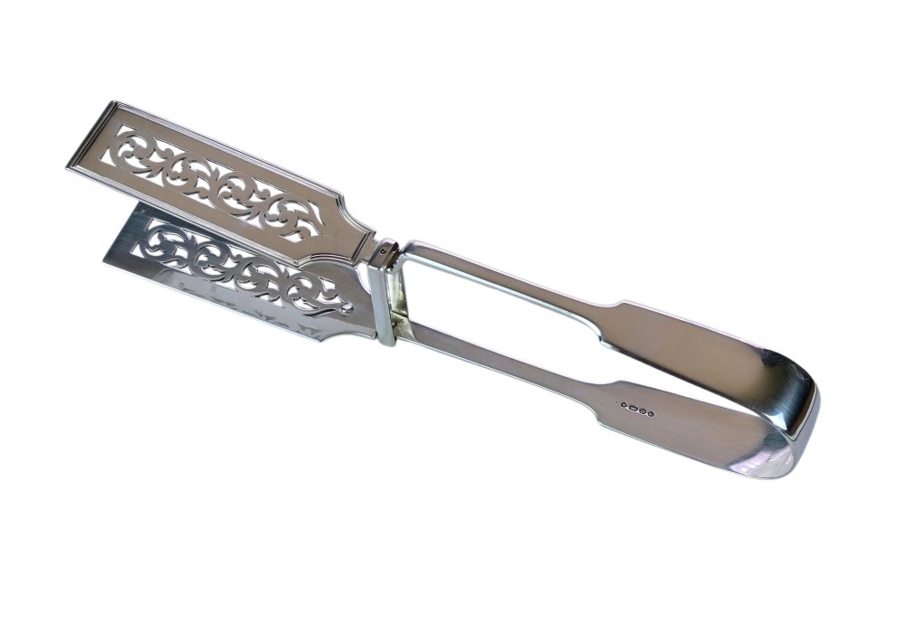Victorian sterling silver asparagus tongs featuring wide, pierced scrollwork blades and clear assay hallmarks along the upper arm. View IV