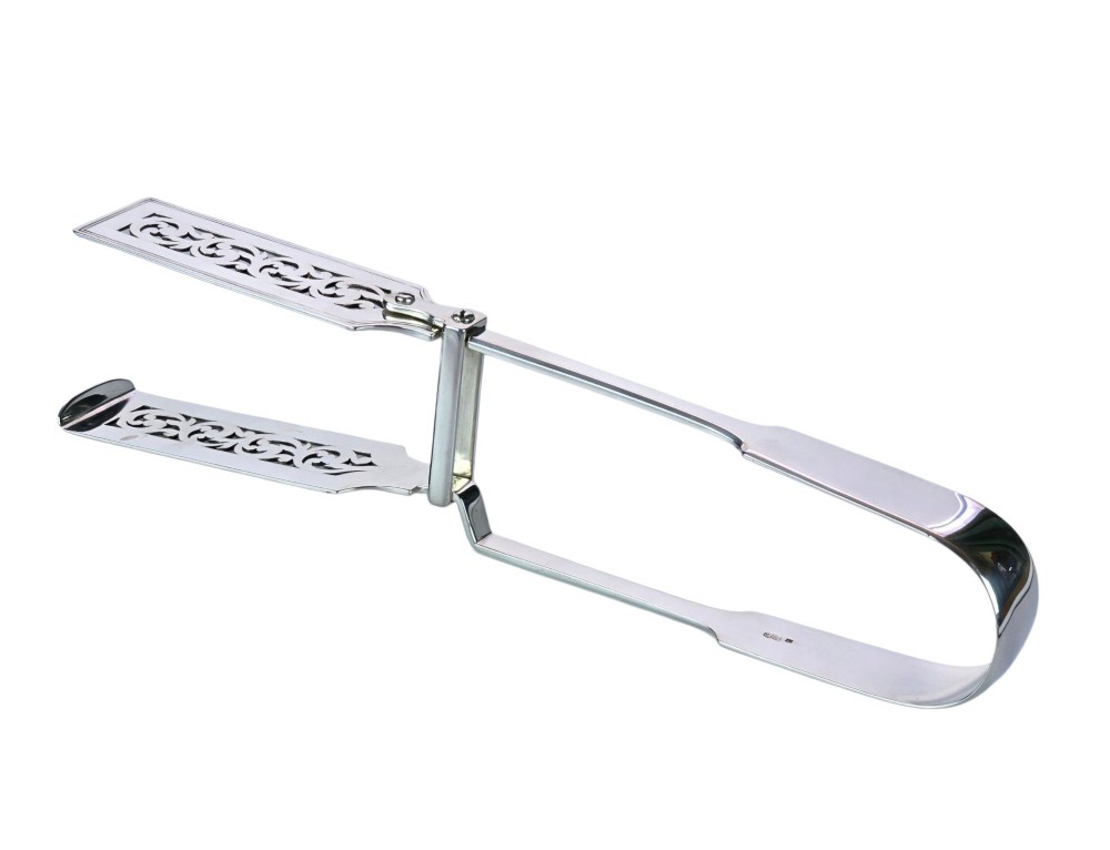 Victorian sterling silver asparagus tongs featuring wide, pierced scrollwork blades and clear assay hallmarks along the upper arm. View V