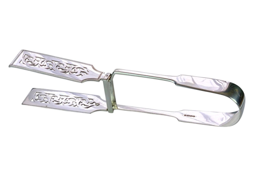 Victorian sterling silver asparagus tongs featuring wide, pierced scrollwork blades and clear assay hallmarks along the upper arm. View VI