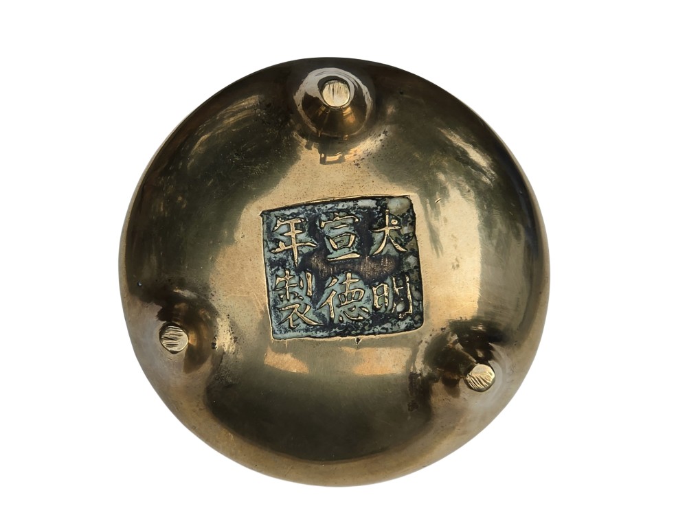 A miniature cast bronze tripod censer featuring loop handles, conical legs, and natural surface patination. View VI