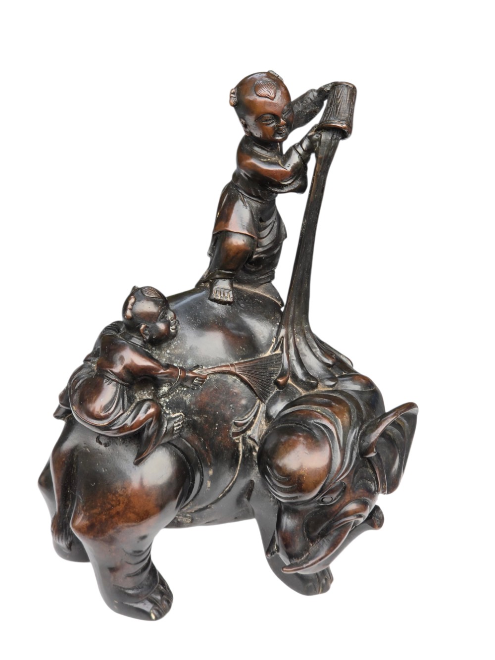 A dark patinated bronze Chinese sculpture depicting two young boys washing a caparisoned elephant. View III