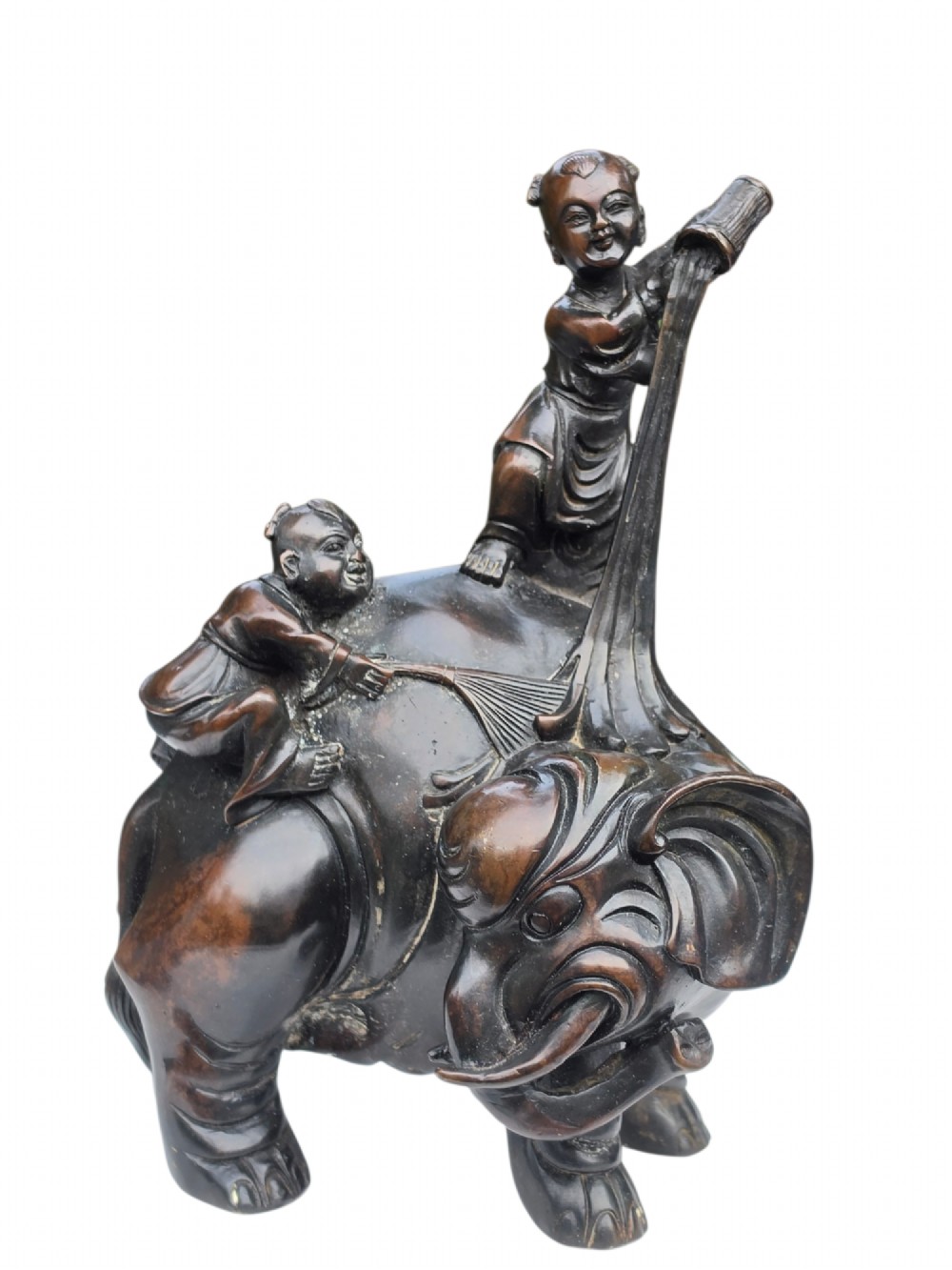 A dark patinated bronze Chinese sculpture depicting two young boys washing a caparisoned elephant. View X
