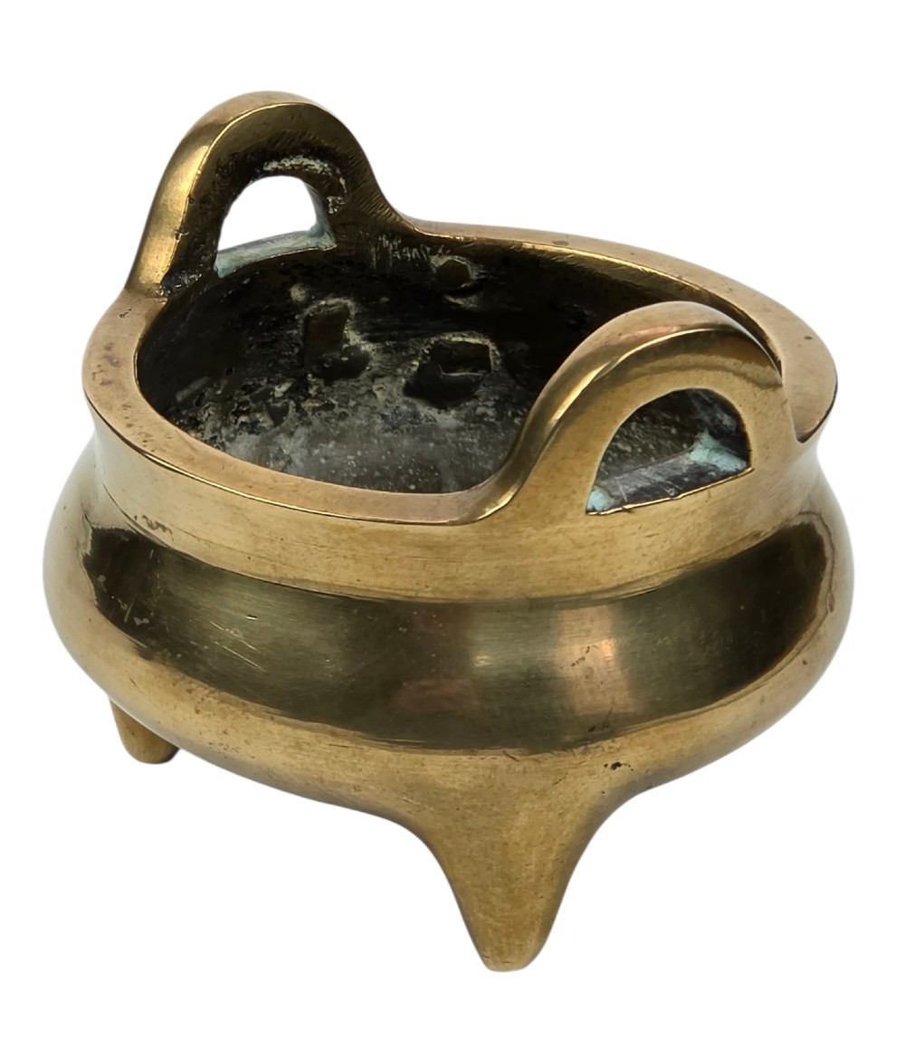 A miniature cast bronze tripod censer featuring loop handles, conical legs, and natural surface patination. View XI