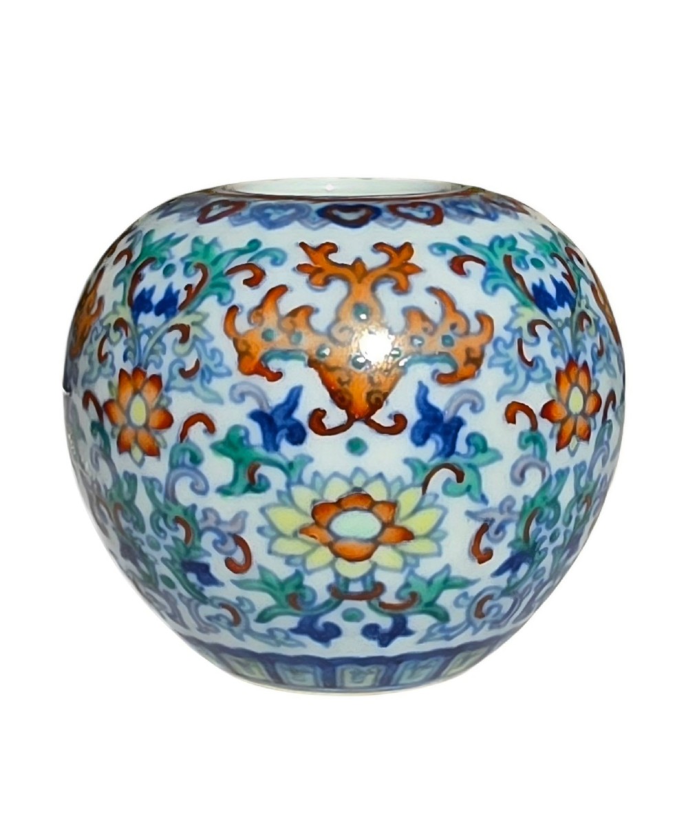 A rounded Chinese porcelain water pot decorated in doucai enamels with lotus flowers, bats, and scrolling foliage. View II