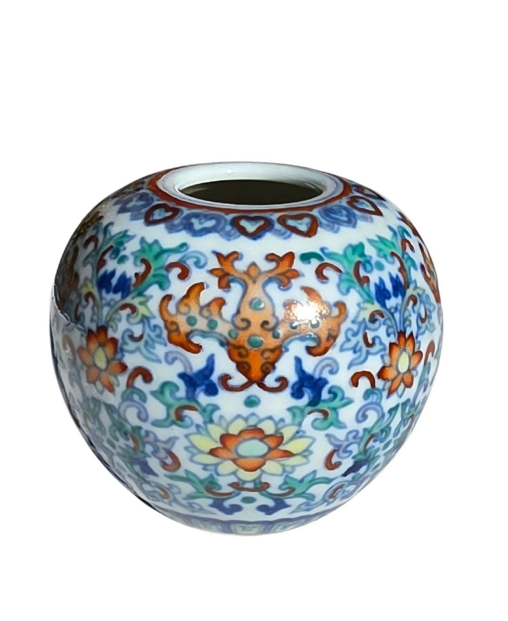 A rounded Chinese porcelain water pot decorated in doucai enamels with lotus flowers, bats, and scrolling foliage. View VIII