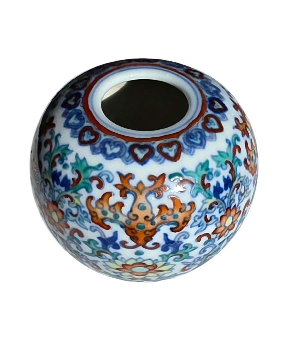 A rounded Chinese porcelain water pot decorated in doucai enamels with lotus flowers, bats, and scrolling foliage. View IX