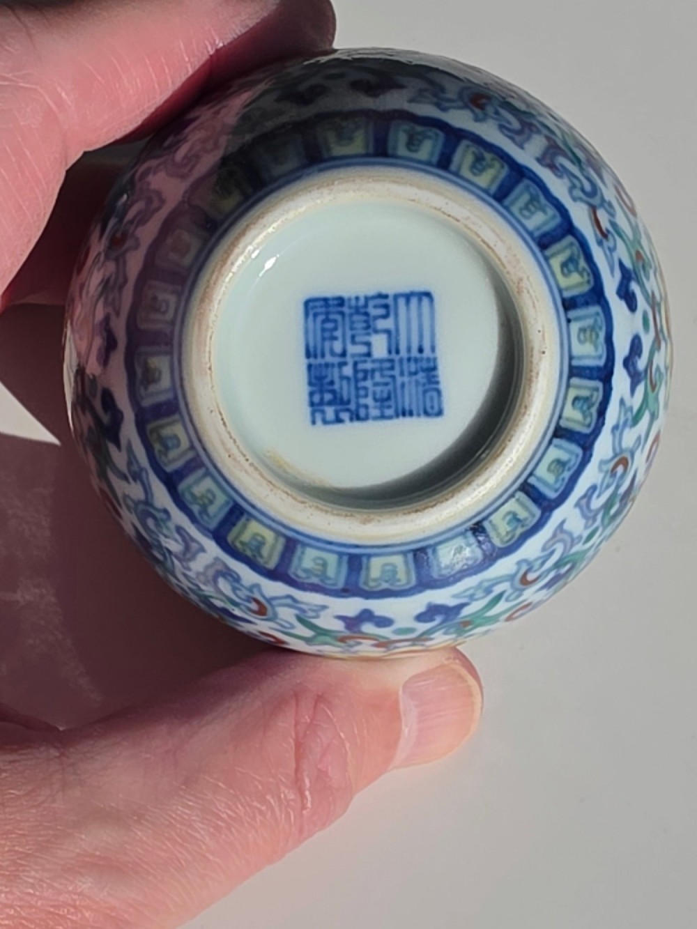 A rounded Chinese porcelain water pot decorated in doucai enamels with lotus flowers, bats, and scrolling foliage. View XV