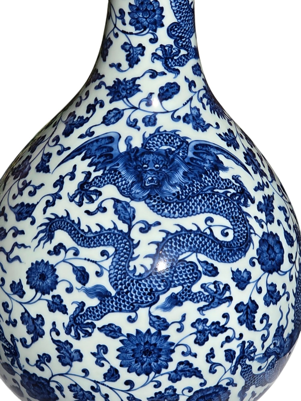 A pear-shaped Chinese porcelain bottle vase decorated with detailed underglaze cobalt blue five-clawed dragons amidst floral scrolls. View IX