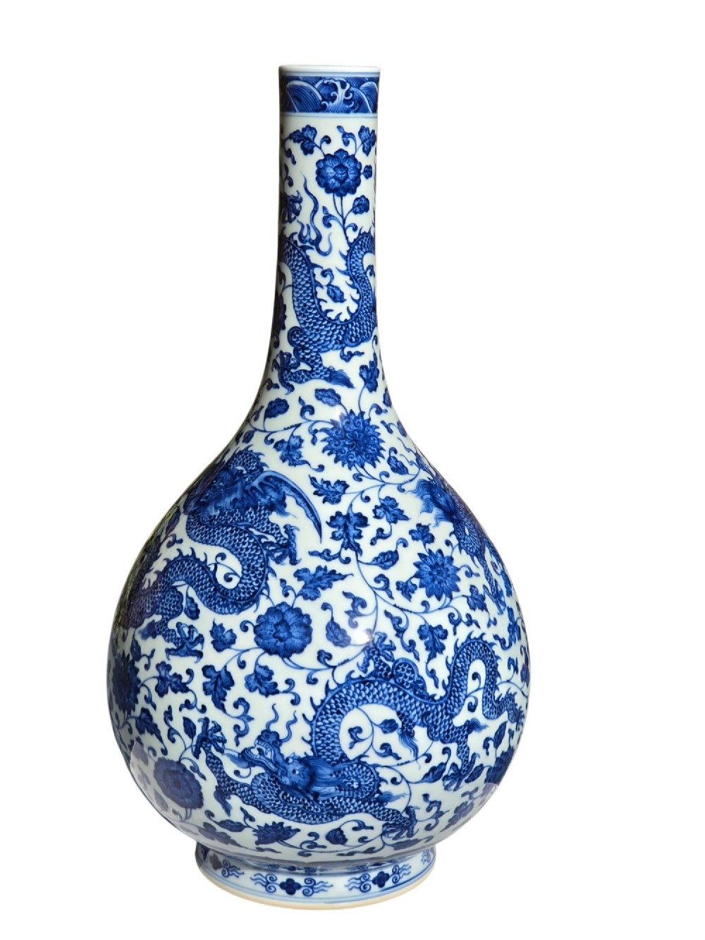 A pear-shaped Chinese porcelain bottle vase decorated with detailed underglaze cobalt blue five-clawed dragons amidst floral scrolls. View XI
