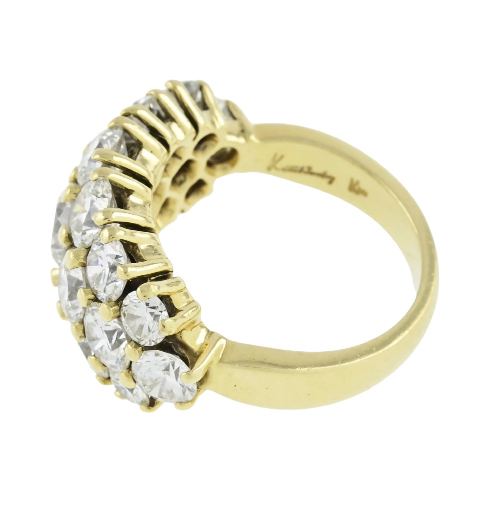 An 18ct yellow gold dome cluster ring closely set with multiple round brilliant cut diamonds in claw settings. View IV