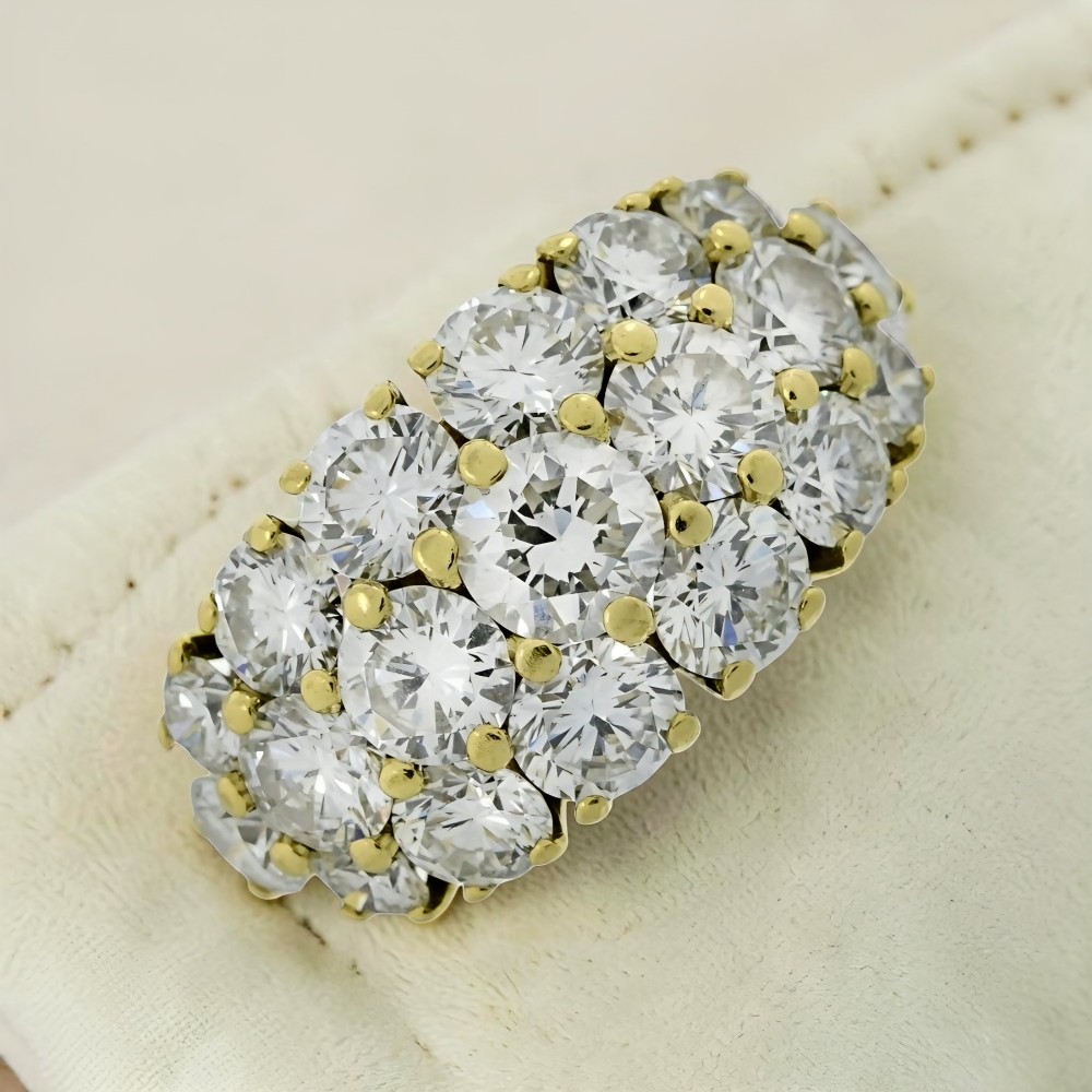 An 18ct yellow gold dome cluster ring closely set with multiple round brilliant cut diamonds in claw settings. View VI