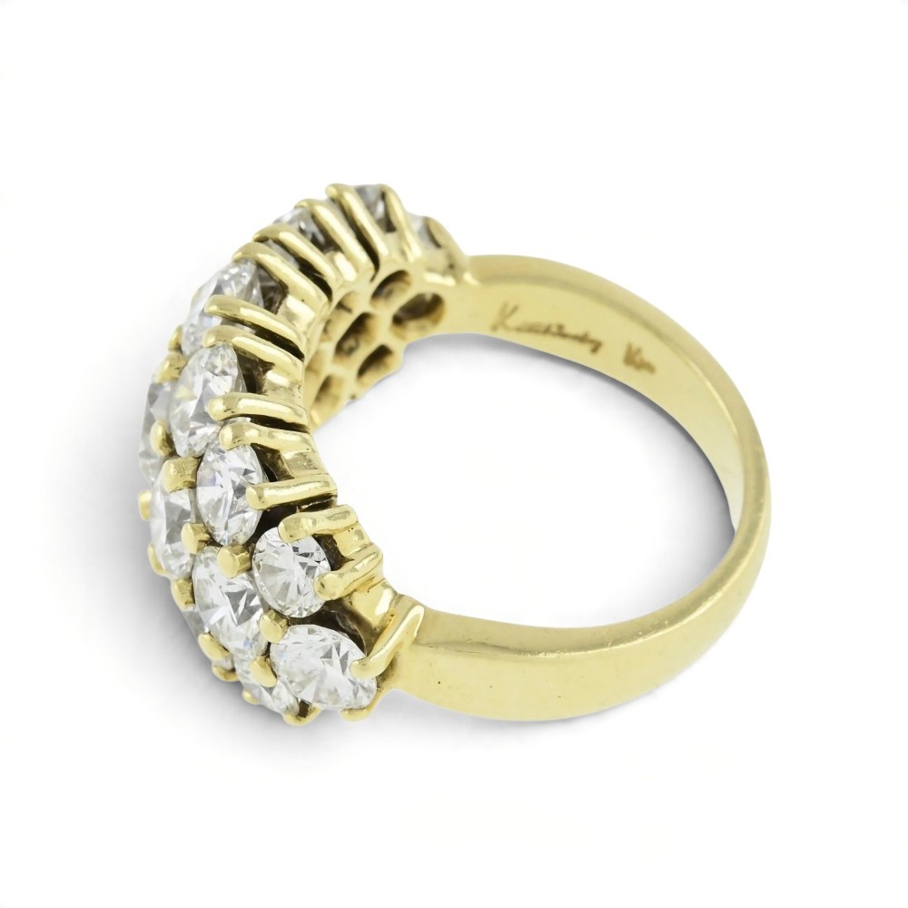 An 18ct yellow gold dome cluster ring closely set with multiple round brilliant cut diamonds in claw settings. View VII