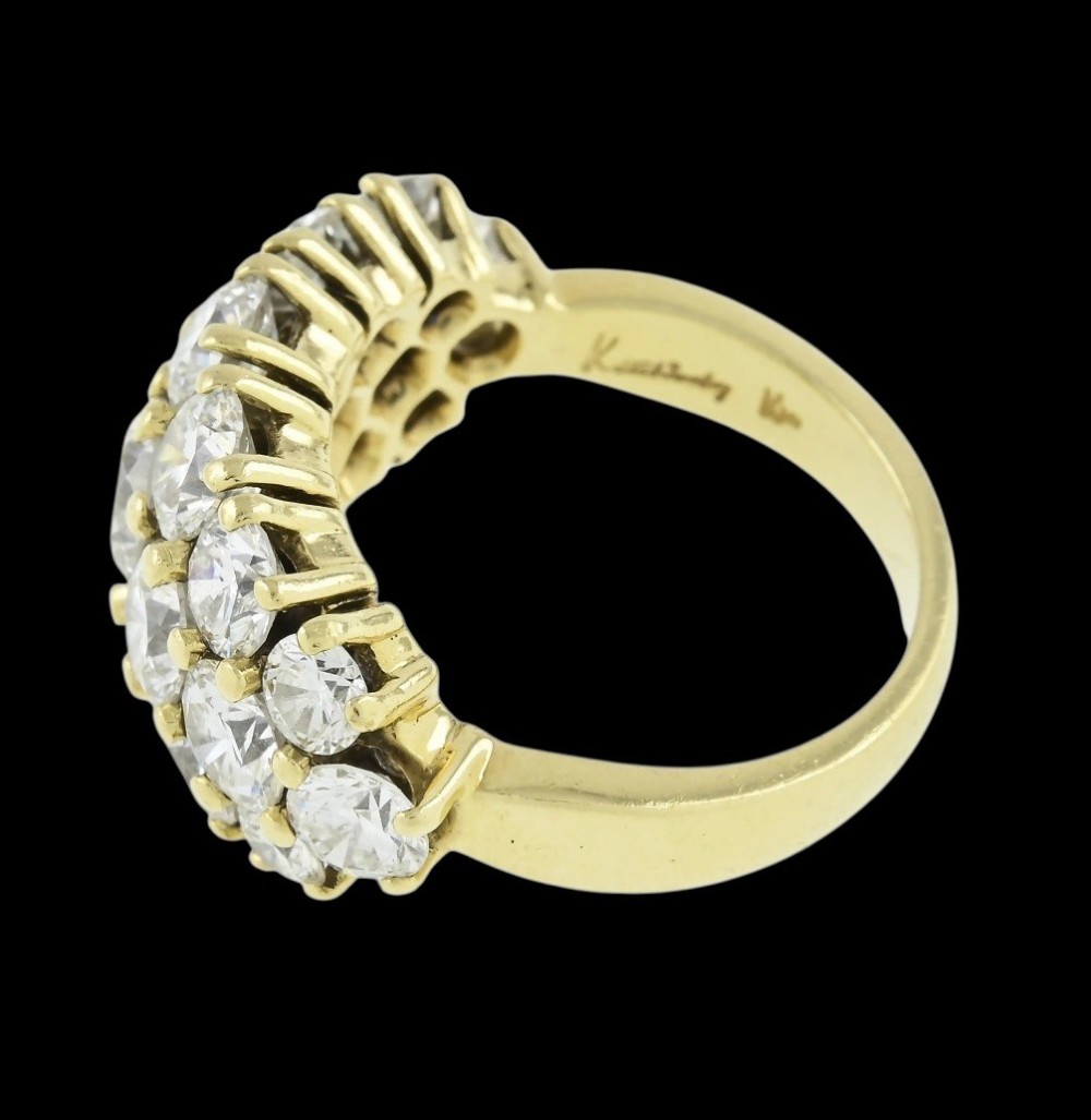 An 18ct yellow gold dome cluster ring closely set with multiple round brilliant cut diamonds in claw settings. View IX