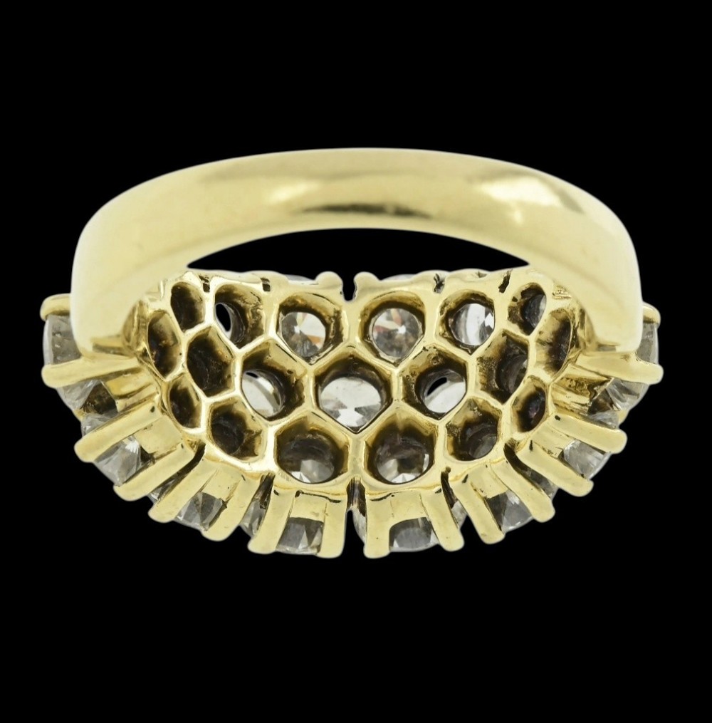 An 18ct yellow gold dome cluster ring closely set with multiple round brilliant cut diamonds in claw settings. View X