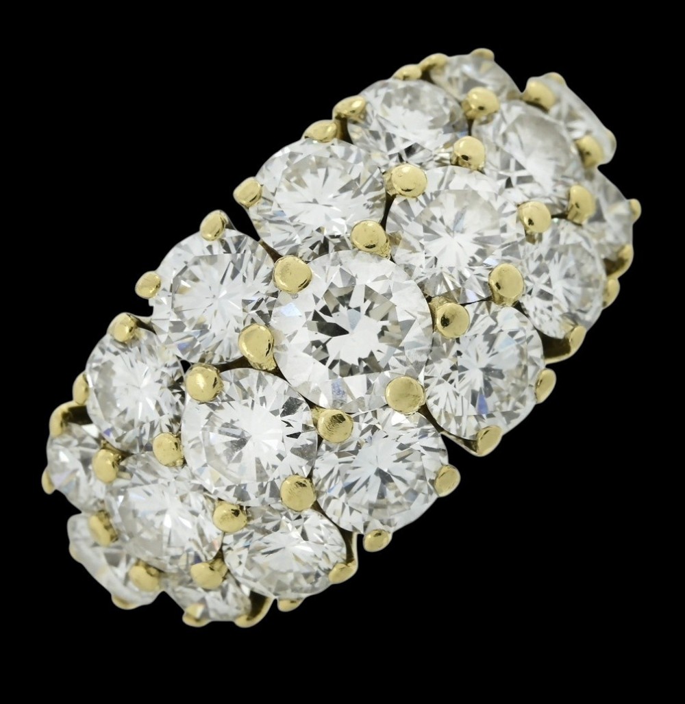 An 18ct yellow gold dome cluster ring closely set with multiple round brilliant cut diamonds in claw settings. View XI