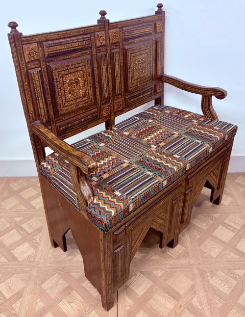 fig 3. A 19th-century double-back Syrian hardwood bench featuring intricate geometric bone and timber parquetry inlay with a patterned upholstered seat.