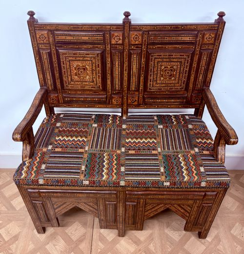fig 4. A 19th-century double-back Syrian hardwood bench featuring intricate geometric bone and timber parquetry inlay with a patterned upholstered seat.