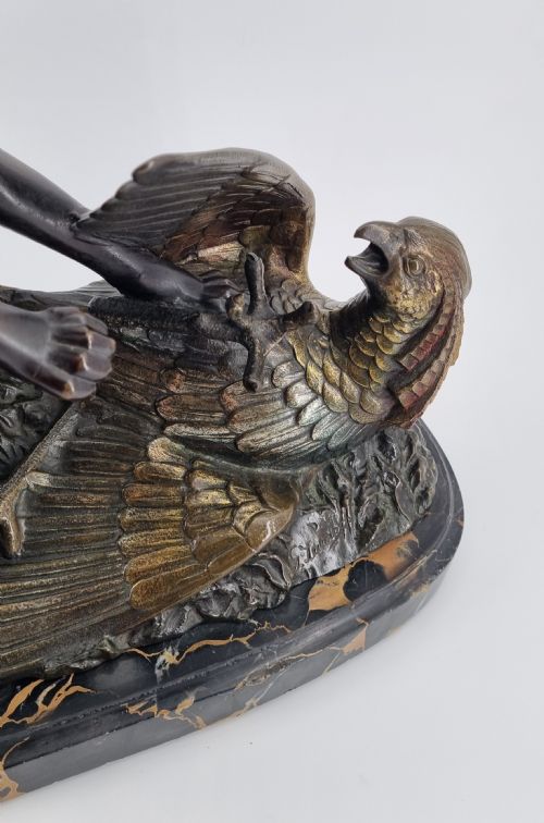 fig 2. A dark patinated bronze sculpture depicting a fox capturing a pheasant mounted on a black veined marble base.