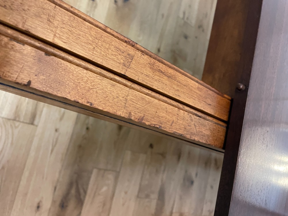 A William IV mahogany extending dining table with a polished surface, rounded corners, and turned reeded legs fitted with brass castors. View VIII