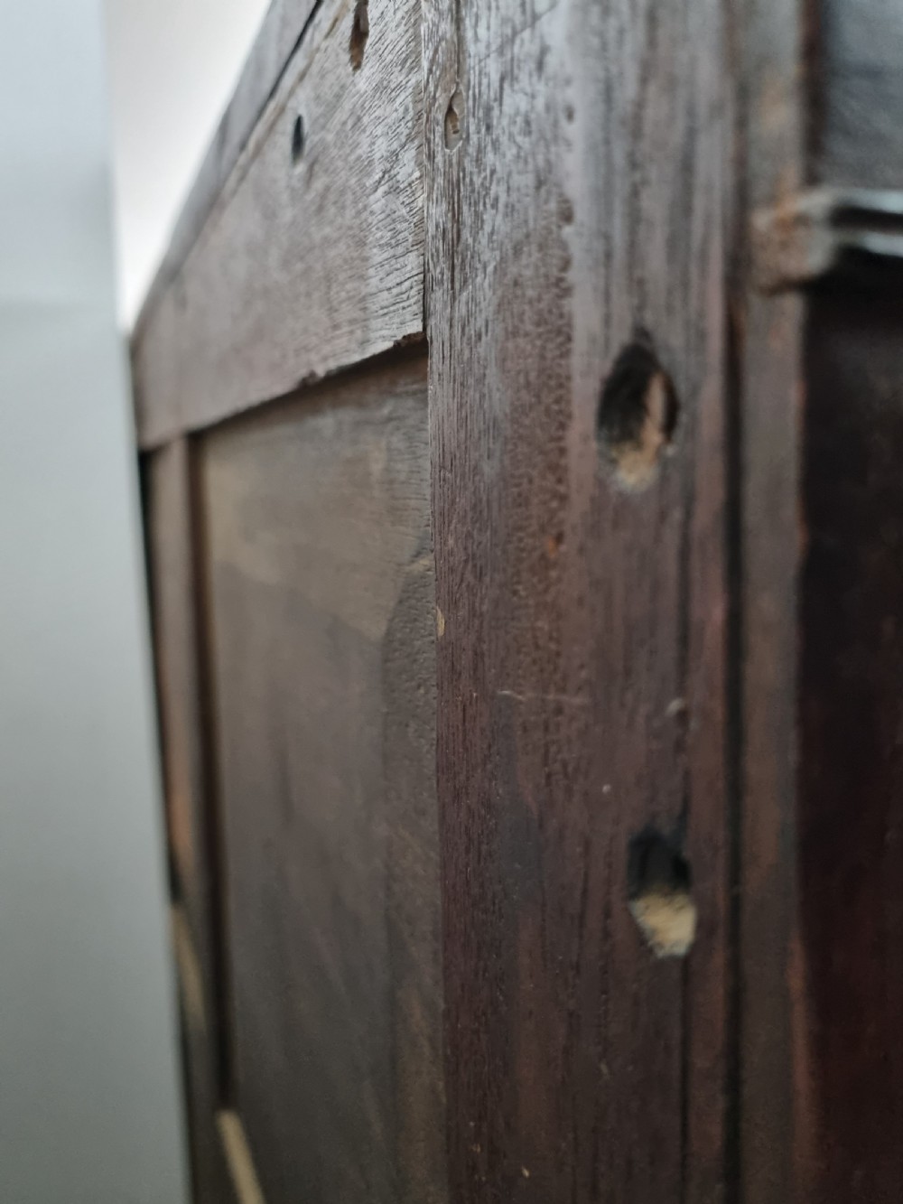 A 19th-century Regency mahogany chest on stand featuring fluted pilasters, lion mask brass ring handles, boxwood stringing, and reeded legs terminating in carved feet. View X