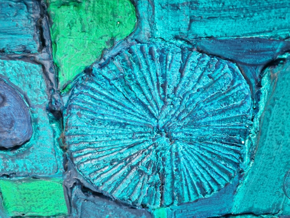 A horizontal rectangular abstract painting featuring raised geometric textures, circles, and relief shapes rendered in vibrant teal, green, and deep blue tones. View IV