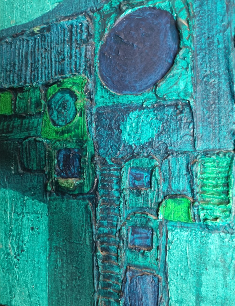 A horizontal rectangular abstract painting featuring raised geometric textures, circles, and relief shapes rendered in vibrant teal, green, and deep blue tones. View X