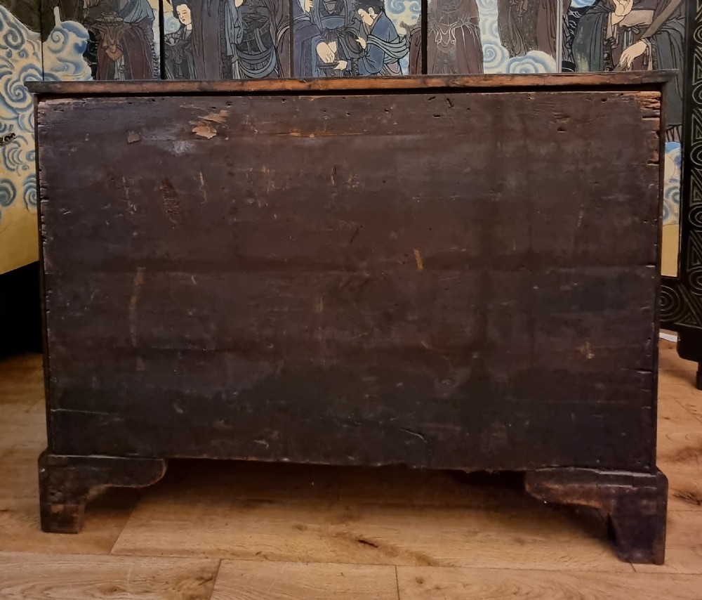 An 18th-century mahogany kneehole desk featuring a serpentine front, green leather inset top, brass hardware, and a central recessed cupboard. View IV