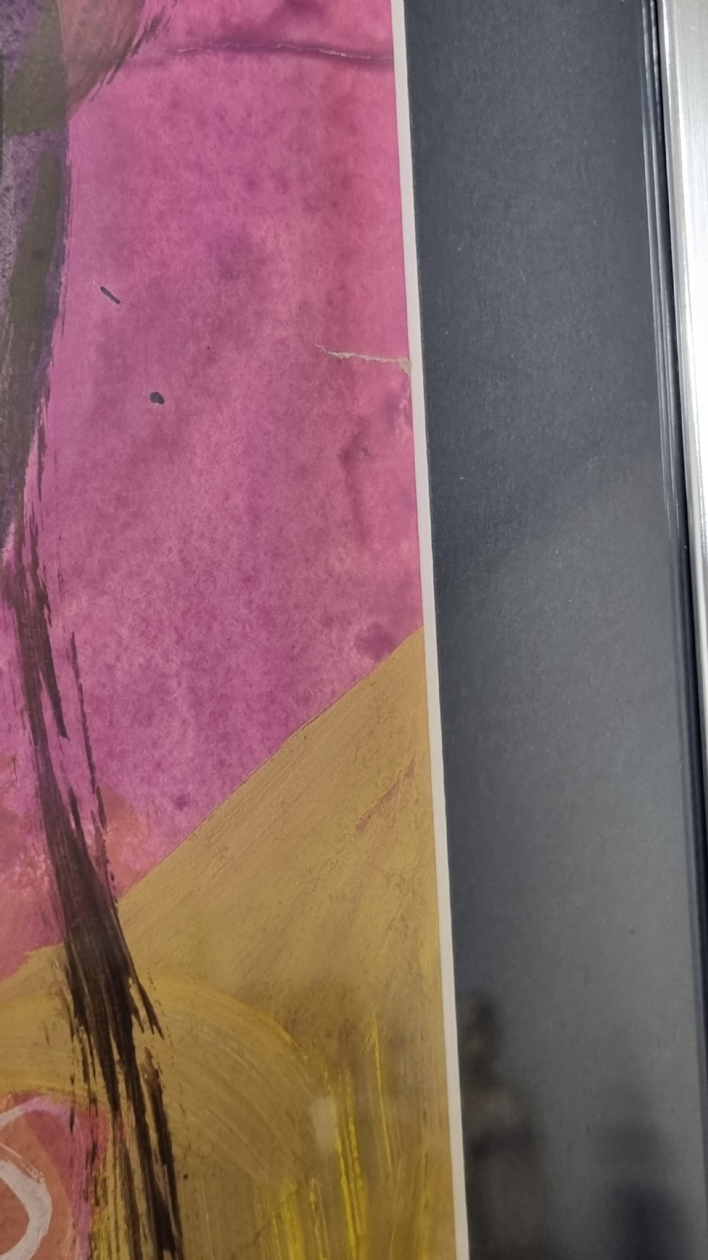 A framed 20th-century abstract mixed media painting on paper featuring energetic fluid linework, vibrant yellow, green, and red hues, set within a silver frame with a dark mount. View V