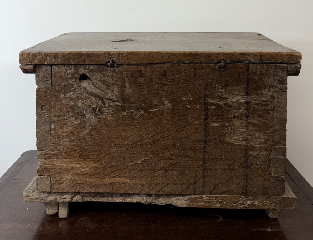 A late sixteenth to early seventeenth-century Flemish oak coffer featuring hand-forged iron clasp hardware, wooden pegs, and a scalloped base plinth. View V