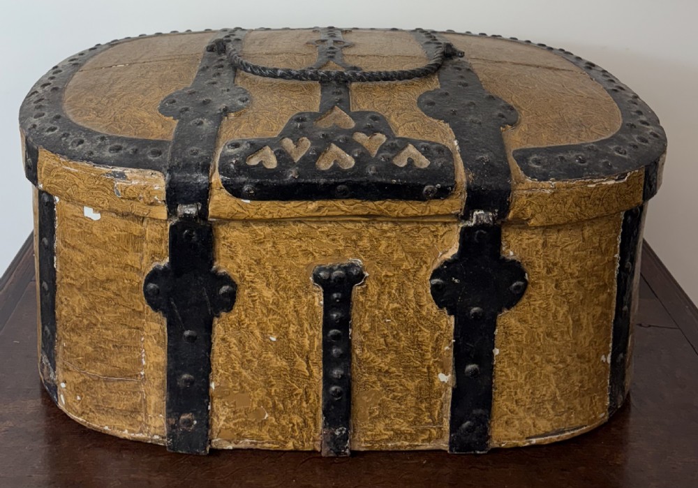 An oval 18th-century Swedish folk art trunk featuring an ochre painted textured finish, dark wrought iron bands, studs, and a heart-shaped latch. View II