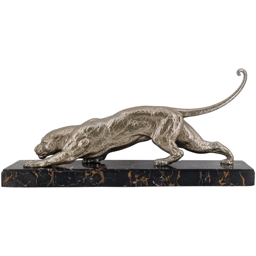 A low-slung, textured silver-toned panther in a crouched hunting posture mounted on a black marble base with gold veining.