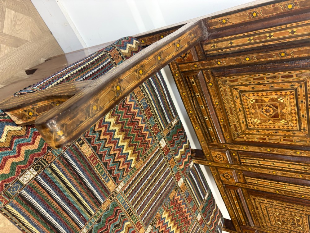 A 19th-century double-back Syrian hardwood bench featuring intricate geometric bone and timber parquetry inlay with a patterned upholstered seat. View XVI